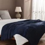 Текстурированное покрывало и плед на кровати с декоративными элементами